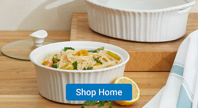 A small white stoneware bowl filled with chicken noodle soup. Shop home.