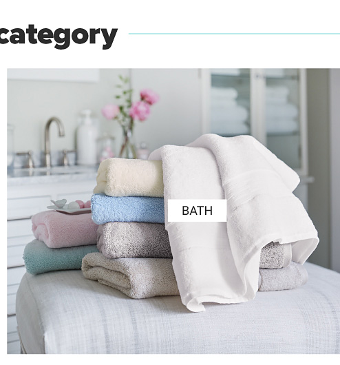 An assortment of folded bath towels in a variety of pastel colors. Shop bath.