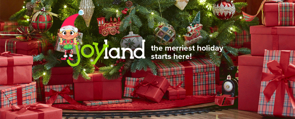 Christmas gifts wrapped in red and green plaid sit under a decorated christmas tree. An animated elf smiles beside the caption, joyland, the merriest holiday starts here