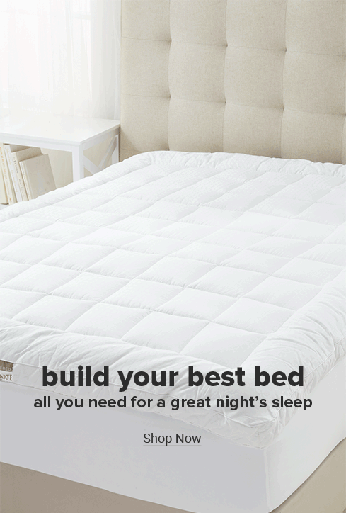 A video of a bed being made with all white sheets, and a cream quilt. Build your best bed all you need for a great nights sleep, shop now. 