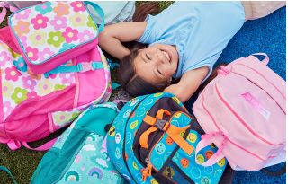 Image of girl laying amongst backpacks
