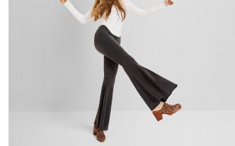 Image of flared jeans Flared Jeans Form-fitting at the top with a wide design from the knees down, these jeans expand to a bell-like flare at the hem.