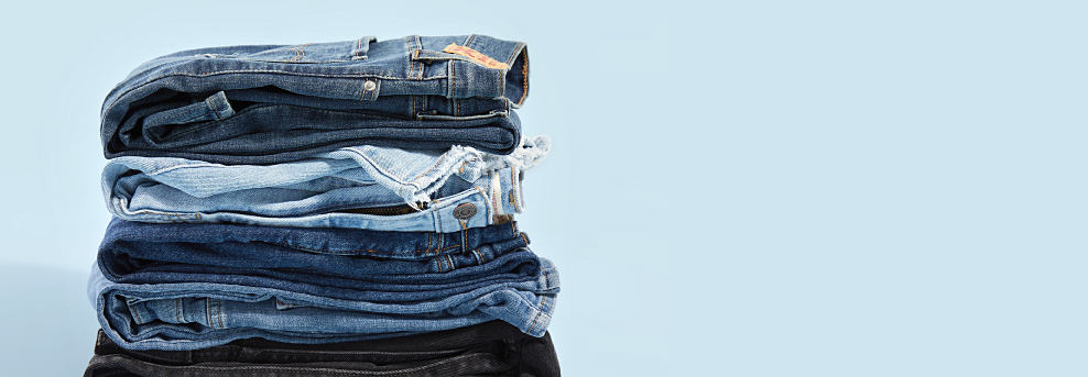 Image of different washes of denim jeans stacked on top of each other