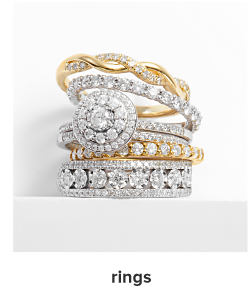 A stack of gold and silver diamond rings. Rings. 