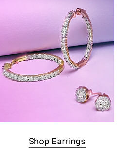 A pair of diamond hoop earrings and a pair of stud earrings. Shop earrings.