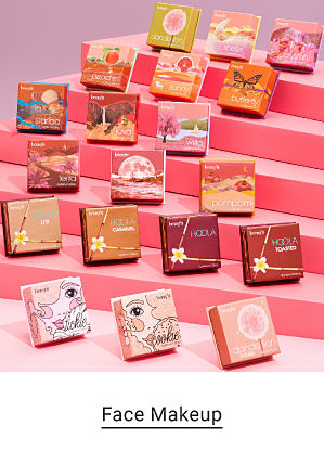 A variety of Benefit Cosmetics face makeup displayed on small pink steps. Face makeup