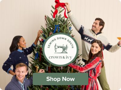 People decorating a Christmas tree. Sewing Down South x Crown & Ivy. Shop now.