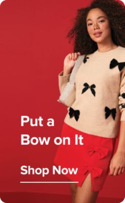 A woman in a bow sweater. Put a bow on it. Shop now.