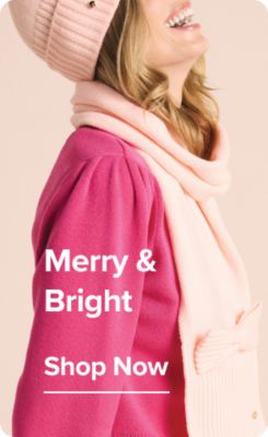 A woman in colorful clothes. Merry & bright. Shop now.