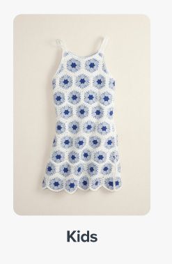 Image of a white dress with blue dots. Shop kids.