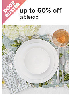 Doorbuster. Up to 60% off tabletop. A table set with a white plate.