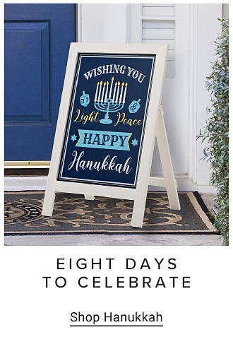 An image of a sign outside a door that says wishing you, light, peace, Happy Hanukkah.