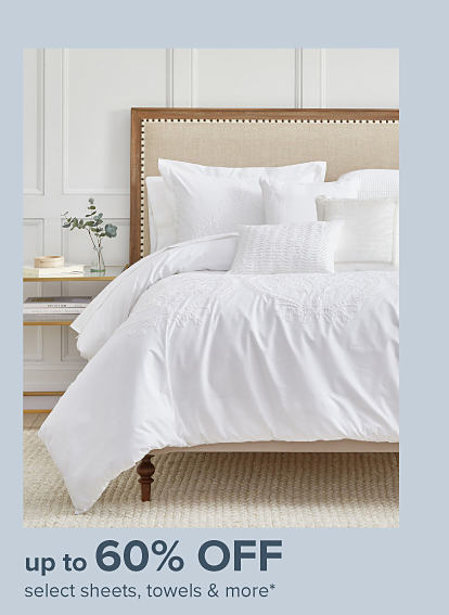 Image of a bed with white linens. Up to 60% off select sheets, towels and more.