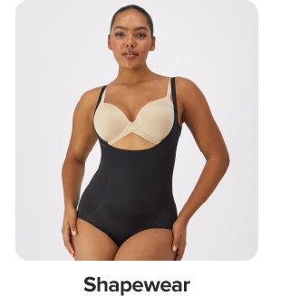 Image of a woman wearing a black bodysuit. Shop shapewear. 
