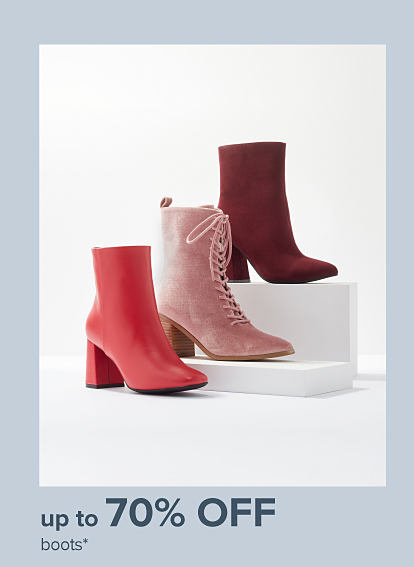 Image of three red and pink boots. Up to 70% off boots.