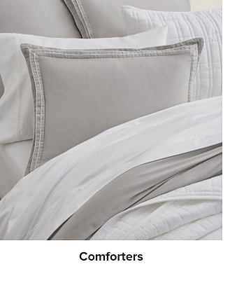 A gray and white bedding set. Shop comforters.