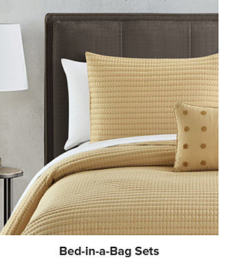 A yellow bedding set. Shop bed in a bag sets.
