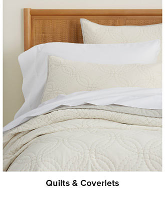 A beige quilt. Shop quilts and coverlets.