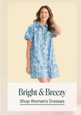 Bright and breezy. Shop womens dresses. A woman in a pink floral dress.