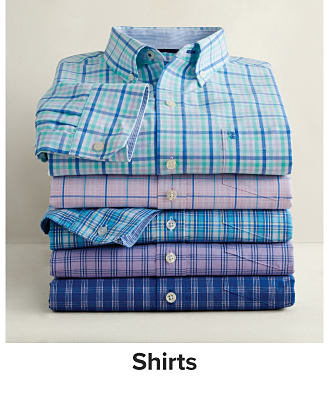 A stack of folded dress shirts. Shop shirts.