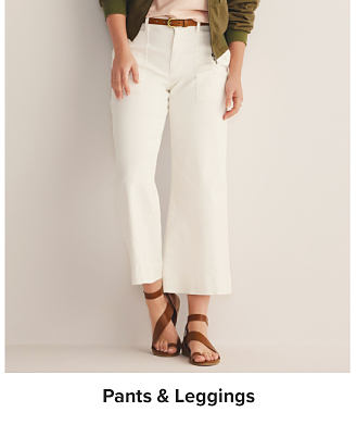 A woman in white pants. Shop pants and leggings.