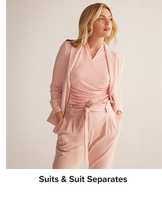 A woman in a pink suit. Shop suits and suit separates.