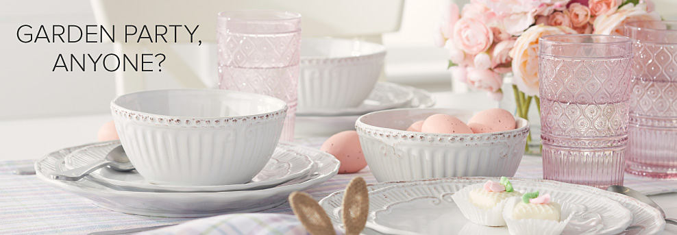 Image of a tabletop with white and pink glasses and plates. Garden party, anyone?