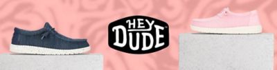 An image featuring two casual shoes and the Hey Dude logo. Women, men, kids.