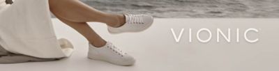 Close up of a woman wearing white sneakers. Vionic. Shop now.