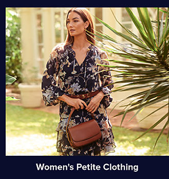 An image of a woman in a dark blue floral dress. Shop women's petite clothing.