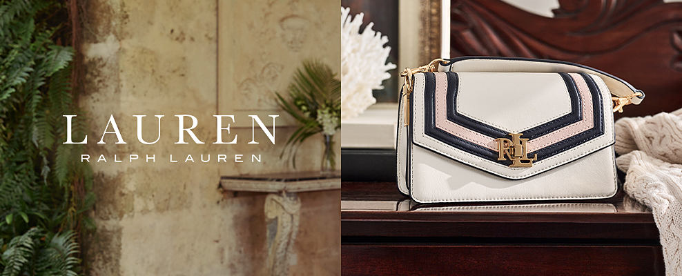 An image of a white handbag with blue and pink stripes and the initials LRL on it. Shop Lauren Ralph Lauren. 
