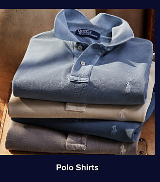 An image of a stack of folded polo shirts. Shop polo shirts
