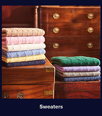 An image of a stack of corded sweaters. Shop sweaters.