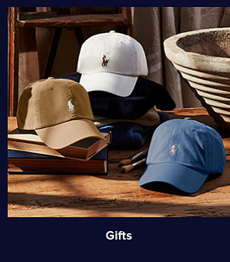 An image of ballcaps in white, brown and blue. Shop gifts.