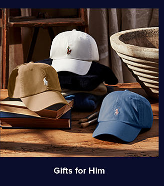 An image of three Ralph Lauren ballcaps in white, brown and blue. Shop gifts for him. 