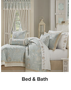 An image of a bed with light blue floral bedding. Shop bed and bath.
