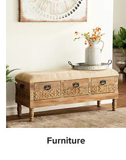 An image of a side table with decor on top. Shop furniture.