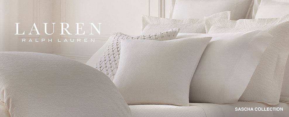 A white bedding set from Lauren Ralph Lauren's Sascha collection. Shop Lauren Ralph Lauren.