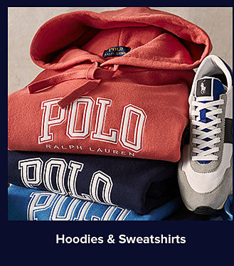 A stack of folded Polo sweatshirts in red and blue. Shop hoodies and sweatshirts.
