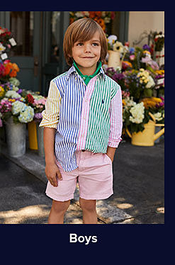 A boy in a yellow, blue, pink and green pastel Polo button up. Shop boys.