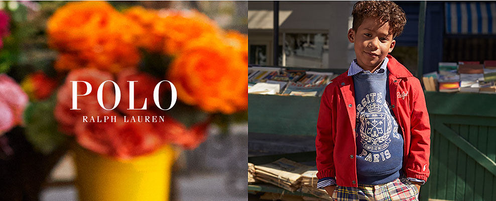 A boy in a red jacket over a blue Polo Ralph Lauren sweater. Polo Ralph Lauren.