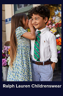 A girl in a blue and green dress and a boy in a white button up, green tie and blue dress pants. Shop Ralph Lauren Childrenswear.
