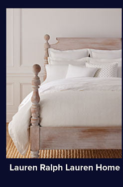 A bedding set in white on a four post bed. Shop Lauren Ralph Lauren Home.