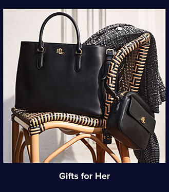Black handbags on a chair. Shop gifts for her