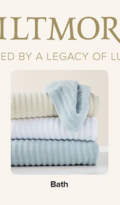 A stack of blue, white and beige bath towels. Shop bath.