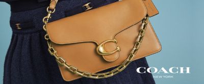 An image of a Coach handbag. The Coach logo.