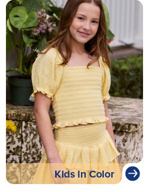 An image of a girl wearing a yellow top and skirt set. Kids in color.