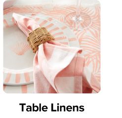 A table with a pink table cloth. Shop table linens.