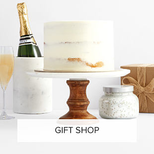 Image of cake and champagne. Shop gifts.