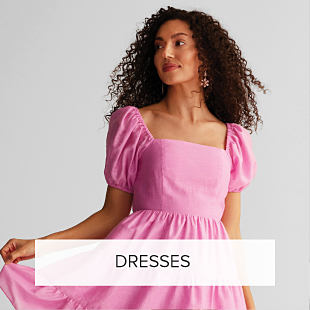 An image of a woman wearing a pink dress. Shop dresses. 